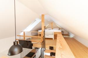 a loft bedroom with a bed and a staircase at Lavender Lodge Bled in Bled