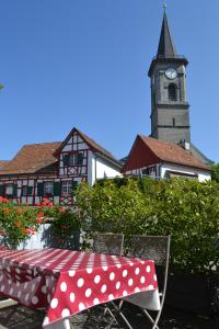 einen Tisch mit einem Tischtuch aus Polyka und einem Uhrturm in der Unterkunft Bachperle in Steckborn