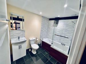 a bathroom with a toilet and a sink and a shower at George & Dragon Hotel in Buckinghamshire