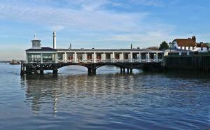 a building on a pier in the water at Linx View 4 Bedroom House in Kent