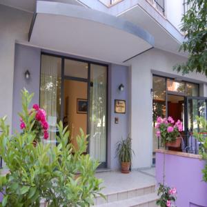 a house with flowers and plants in front of it at Hotel Danubio in San Mauro a Mare