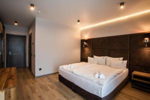 a bedroom with a large bed with white pillows at Premium Club SPA in Bukovel
