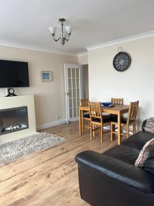 a living room with a couch and a dining room table at Castle View Dover in Dover