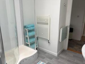 a bathroom with a shower and some blue towels at Castle View Dover in Dover