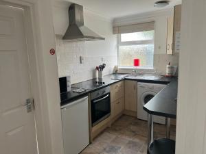 a kitchen with a sink and a stove top oven at Castle View Dover in Dover