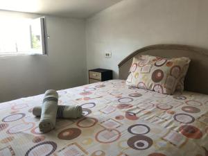 a bedroom with a bed with a stuffed animal on it at Apartments OldTown in Podgorica