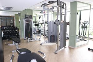 a gym with a bunch of tread machines in it at The Quart Ruamrudee by UHG in Bangkok