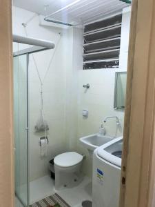 a small bathroom with a toilet and a sink at Estúdio 73 in Sao Paulo