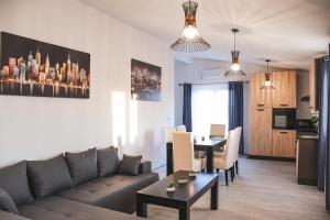 a living room with a couch and a table at Apartments Olea in Biograd na Moru