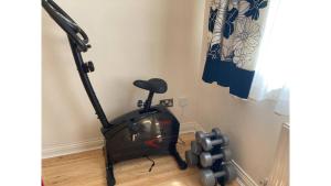an exercise bike in a corner of a room at Pass the Keys Central Oxford 2 Bed Apartment with Parking in Oxford