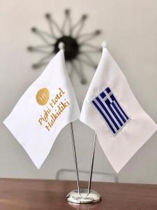 two flags sitting on top of a wooden table at Hotel Pighi in Kriopigi