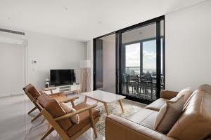 a living room with a couch and a table at Sea view Beachfront apartment in surfers in Gold Coast