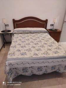a bed in a bedroom with two nightstands and two tables at Prado-Gijon in Gijón