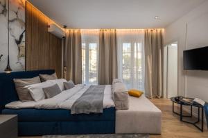 um quarto com um sofá azul e uma televisão em Bella Vita Apartments em Rijeka