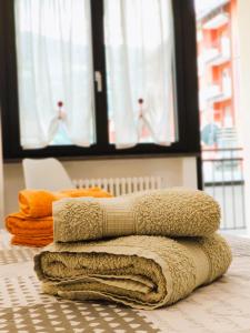 a pile of towels sitting on top of a table at A, C or D - MyAostaProject Rentals in Aosta