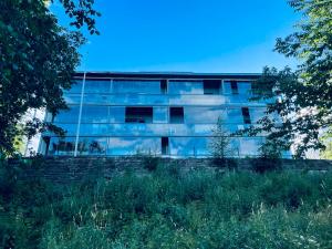 an office building with a lot of glass windows at Tallinn Seaside Apartment in Tallinn