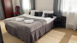 Postel nebo postele na pokoji v ubytování Hotel Camelot