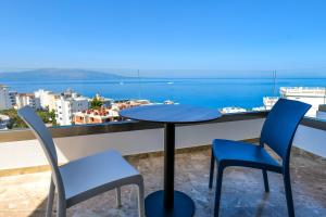 a table and two chairs on a balcony with a view at Sea View Hotel in Sarandë