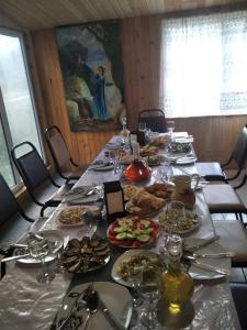 un lungo tavolo con piatti di cibo sopra di Guesthouse Nakudurta a Dart'lo