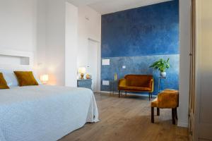a bedroom with a bed and a chair at Casa Mediterranea in Nurachi