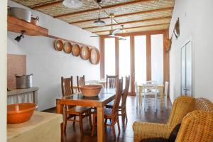 a kitchen and dining room with a table and chairs at Casa Mediterranea in Nurachi