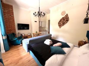 a living room with a couch with two stuffed animals on it at Brick Castle - Apartament Ulrich in Wrocław