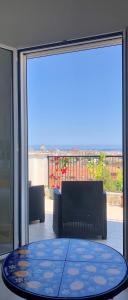 a glass door with a table in front of a balcony at B&B Bellavista in Palermo