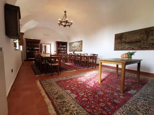 uma sala de jantar com mesa e cadeiras e um tapete em Convento dei Cappuccini em Tolfa