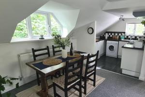 a kitchen with a table and chairs in a room at Park House Self-Contained Annex in Mold