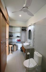 a bathroom with a toilet and a sink at Bali Harmony Retreat in Canggu