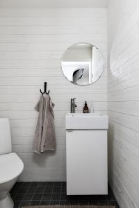 a white bathroom with a sink and a mirror at Charming Villa at Askersund Golf Resort in Åmmeberg +16 photos