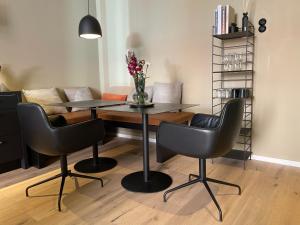 a dining room with a table and chairs and a couch at Fisher´s Loft Studio in Lübeck