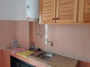 a kitchen with a sink and a counter top at bel appartement dans une residence calme in Martil