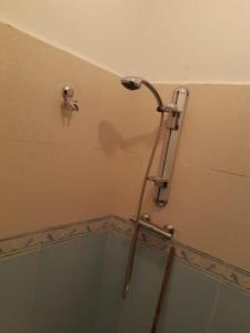 a shower head on the wall of a bathroom at bel appartement dans une residence calme in Martil