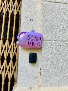 a purple bottle on the side of a building at Sophia Homestay PP in Phnom Penh