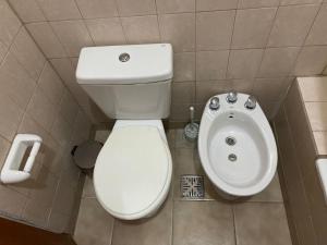 a bathroom with a toilet and a sink at Complejo Las Moras in Santa Rosa +10 photos