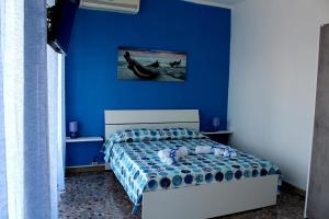 a blue bedroom with a bed and a blue wall at Blue Dream in Gaeta