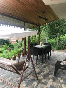 a patio with an umbrella and a table and chairs at Doğa apart 