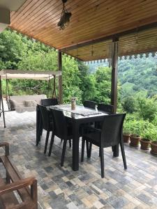 a black table and chairs on a patio at Doğa apart 