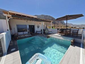 a swimming pool in front of a house at Tramonto Luxury Villa No2 - Breathtaking sunset view in Karpathos Town