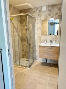 a bathroom with a shower and a sink at Désirée in Le Bosc