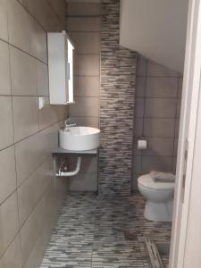 a bathroom with a sink and a toilet at Palio Villa in Paleo Tsifliki