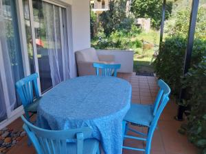 a blue table and chairs on a patio at Palio Villa in Paleo Tsifliki