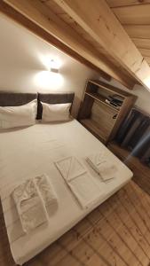 a large white bed with two towels on it at Petrina Bolosis in Palaiókastron +53 photos