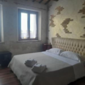 a bedroom with a bed with two towels on it at Casale della rosa in Loreto