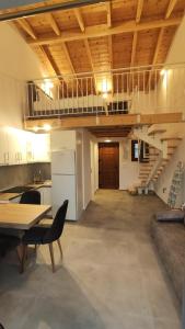 a large room with a staircase and a table and chairs at Petrina Bolosis in Palaiókastron