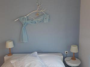 a blue room with a bed and two lamps at Palio Villa in Paleo Tsifliki