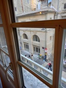 a view of a street from a window at Studio cocooning centre historique d Avignon in Avignon