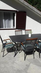 a picnic table and two chairs sitting on a patio at Apartments by the sea Cove Vela Stiniva, Hvar - 19951 in Zastražišće +14 photos