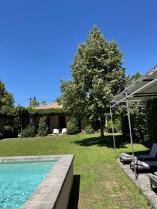 a house with a swimming pool and an umbrella at Loft 52 in Aix-en-Provence